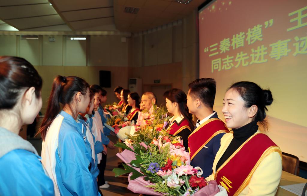 乐游棋牌学生为报告团成员献花